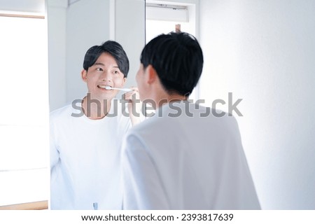 Japanese man with a toothbrush Royalty-Free Stock Photo #2393817639
