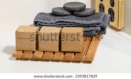 Shower cap sanitary bags and face washers in a motel bathroom Royalty-Free Stock Photo #2393817829