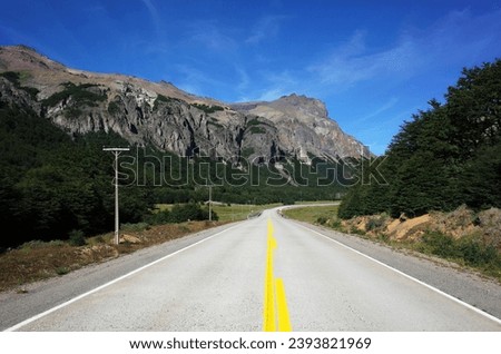 The legendary highway Carretera Austral (Ruta 7 ) passes through the Cerro Castillo National Park in southern Chile, Patagonia, Road with yellow line at picturesque mountains in sunny day Royalty-Free Stock Photo #2393821969