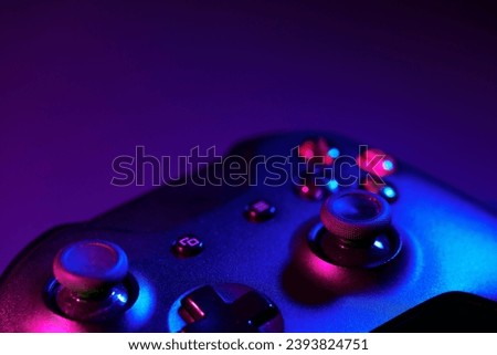 Gaming joystick on black background in neon light
