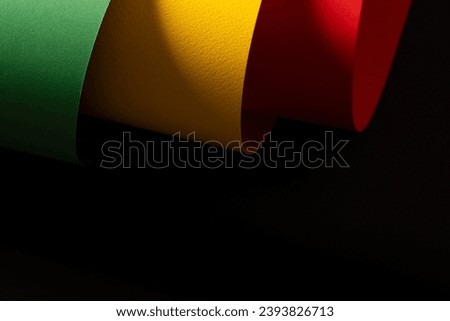 Green, yellow and red papers with copy space on black background. Black history month, africa, black culture and history concept.