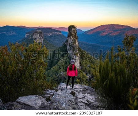 hiker girl admiring unique view from the top of stern, main range national park, queensland, australia; famous steamers trailhead near brisbane; Royalty-Free Stock Photo #2393827187