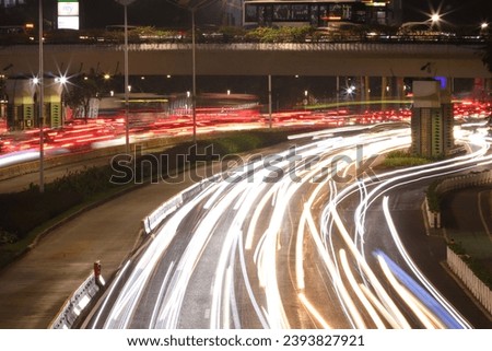 Traffic lights capture at night around Jakarta business district in Sudirman street, Indonesia. 