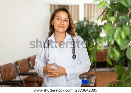 Positive female doctor posing in clinic