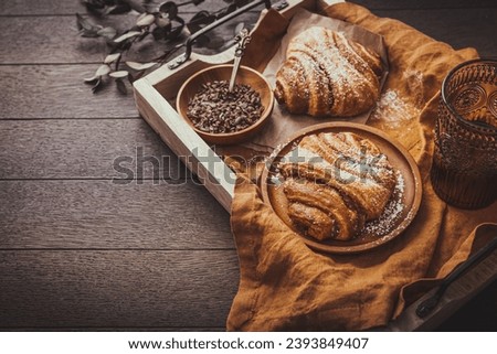 Cinnamon rolls or Franzbroetchen -  Germany sweet pastry sweet pastry baked with butter and cinnamon,  croissant with cocoa chips Royalty-Free Stock Photo #2393849407