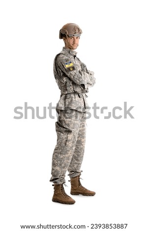 Young male soldier with Ukrainian chevrons isolated on white background