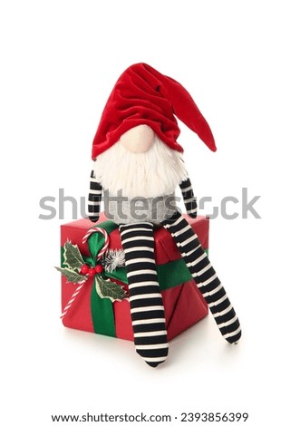 Christmas gnome with gift box isolated on white background