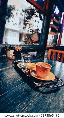 a cup of Turkish coffee served on  tray on a green wooden table in coffee shop, Vintage effect picture style pictures