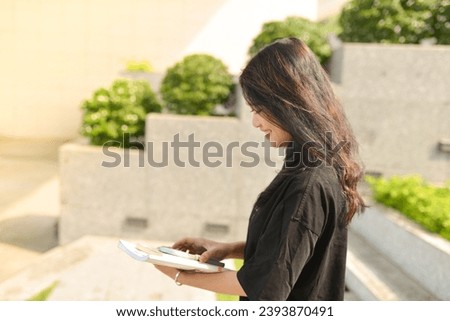High-quality, free stock photo college students in campus environment, studying, enjoying simple moments, authenticity, a day in the life. Young Asean girl