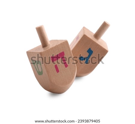 Wooden dreidels isolated on white. Traditional Hanukkah game Royalty-Free Stock Photo #2393879405