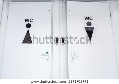 Toilet sign on the door outside in the park