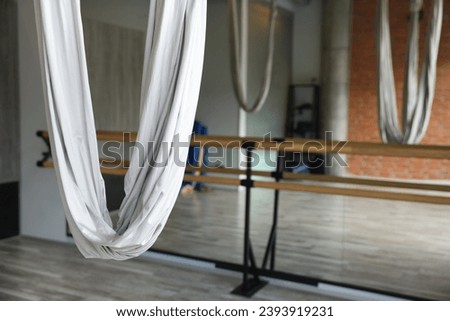 Many hammocks for fly yoga in studio, space for text