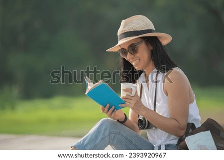 asian woman traveler with backpack relaxing outdoor with sitting on quayside relax read book during coffee break on background summer vacations and lifestyle hiking concept.