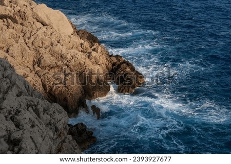 Waves beat against the coastal sea rock