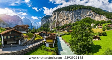 Lauterbrunnen valley with famous church and Staubbach waterfall. Lauterbrunnen village, Berner Oberland, Switzerland, Europe. Spectacular view of Lauterbrunnen valley in a sunny day, Switzerland. Royalty-Free Stock Photo #2393929165