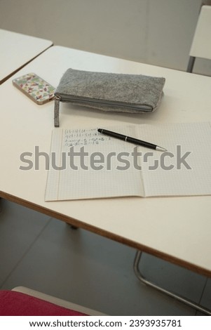 Math notebook lying open on desk in classroom
