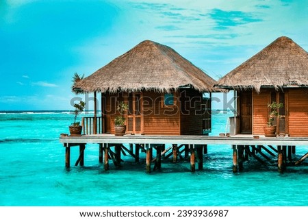 Maldives tropical Island, beautiful isolated luxury water bungalows Maldives in the blue green ocean of the Maldives Island, turqouse colored ocean  Royalty-Free Stock Photo #2393936987