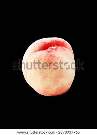 A closeup of a peach on a black background