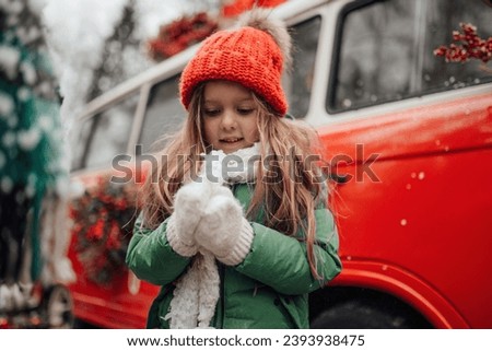 Female child celebrating Christmas and New Year winter holidays season outdoor. Active little girl joyful spending time at coniferous forest enjoying childhood