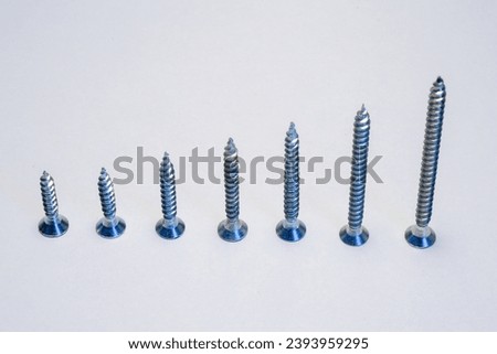 Chipboard screws with a diameter of 3.5 mm and lengths of 18, 20, 25, 30, 35, 40, 50 mm Royalty-Free Stock Photo #2393959295