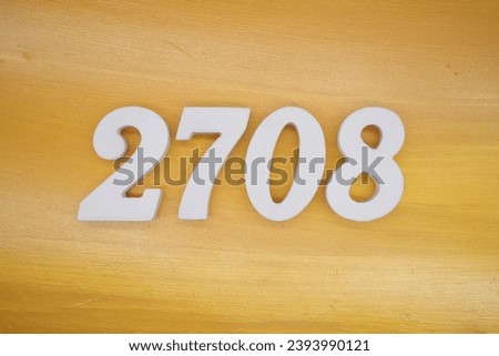 The golden yellow painted wood panel for the background, number 2708, is made from white painted wood. Royalty-Free Stock Photo #2393990121