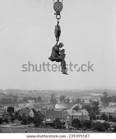 Washington, D.C. photographer hangs from a crane to capture a view of the city in 1923.