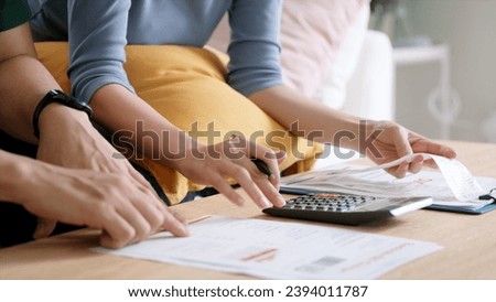 Rising high cost of living in low poor income asia people family. Past due bill debt home loan money issue young adult asian couple man woman worry shock sad tired stress in raise tax rate crisis Royalty-Free Stock Photo #2394011787