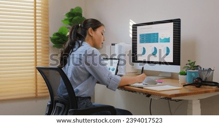 Smart Gen Z tech talent workforce typing SEO sale report on desktop PC happy work easy relax at home office. Remote WFH reskill upskill job MBA study of young people asia woman examine big data graph. Royalty-Free Stock Photo #2394017523