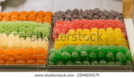 Counter with various types of handmade fruit gummy candies. Royalty-Free Stock Photo #2394034579