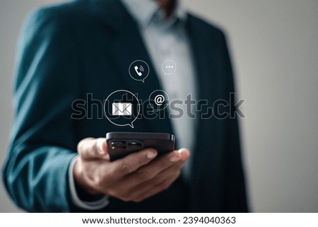 Contact us concept. Businessman using smartphone with contact us icon or Customer support hotline people connect.
