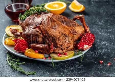 Homemade baked duck with oranges, berries and herbs. Crispy whole roast duck. Thanksgiving or Christmas dinner. place for text, top view.