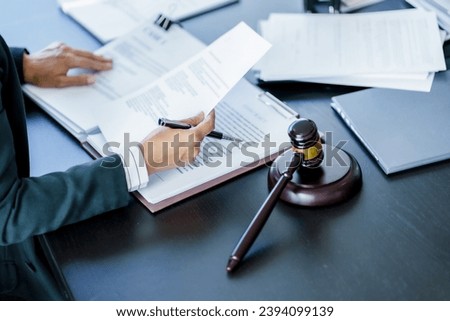 Lawyer working legal data contract at workplace.
