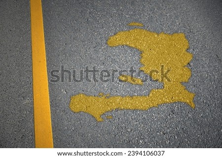 yellow map of haiti country on asphalt road near yellow line. concept