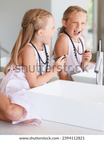 Kid, lipstick and smile for mirror in bathroom with mark, writing or drawing with bad behavior. Little girl, happy and laugh for picture, naughty and problem with mom, makeup or cosmetics for beauty