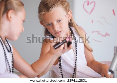 Little girl, lipstick and heart on mirror in bathroom for drawing, fun and picture with bad behavior. Young, child and determined expression for writing with cosmetics for trouble, mess or problem