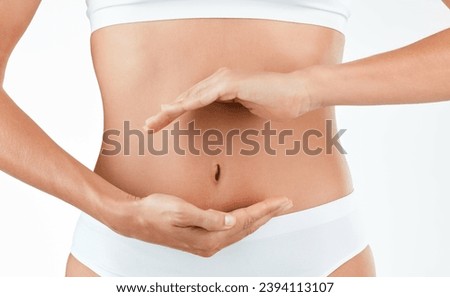Stomach, wellness and hands of woman in studio for digestion, gut or health on white background. Abdomen, detox and lady person with finger shape for healthy, balance or weight loss, control or diet