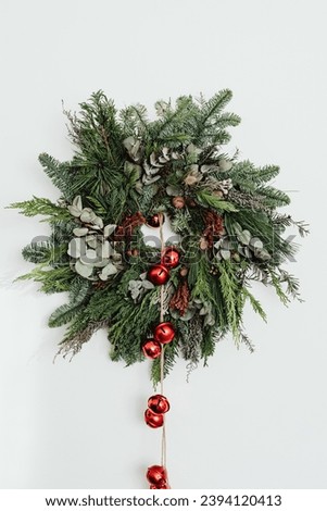 A Wreath with christmas ornaments on white background