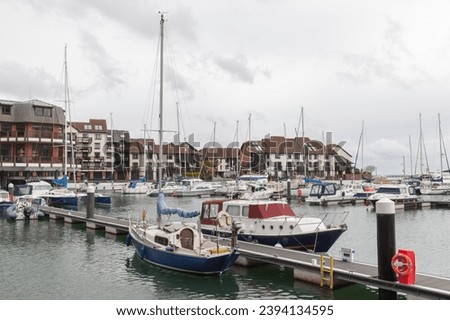 Sailing yachts and pleasure motor boats are moored in Southampton marina, United Kingdom Royalty-Free Stock Photo #2394134595
