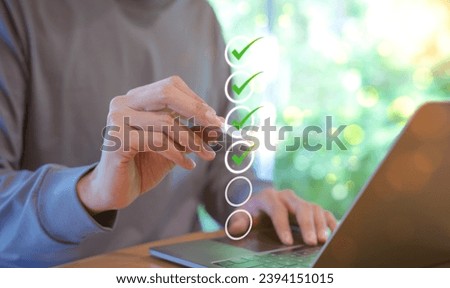 Man using pen to tick correct sign mark in checkbox for quality document control checklist and business approve project concept. Check mark, Filling out digital form, Online exam, Knowledge quiz,