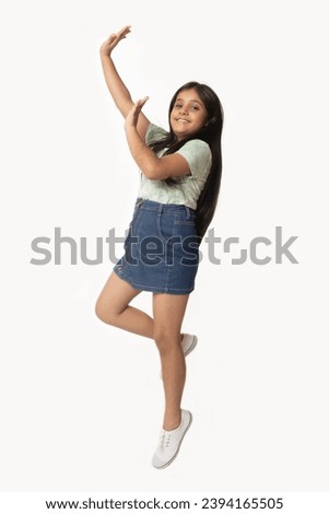 Dancing Girl. Cute lovely attractive cheerful cheery straight-haired blonde girl Full length body size photo of small girl smiling happily keeping long hair isolated on white color background