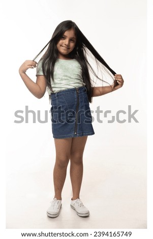 Nice-looking cute lovely attractive cheerful cheery straight-haired blonde girl Full length body size photo of small girl smiling happily keeping long hair isolated on white color background