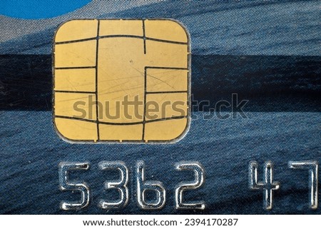 Generic credit card close-up detail with numbers and scratched chip