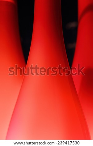 Abstract background with red glass lampshades, close up, selective focus