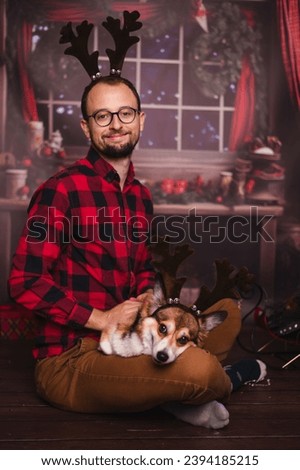 Dog owner and corgi Christmas picture