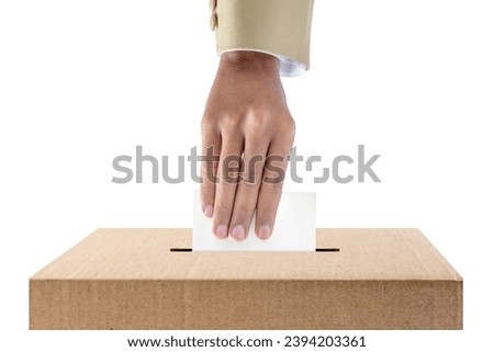Human hand inserts vote paper into ballot box isolated over white background. Election concept