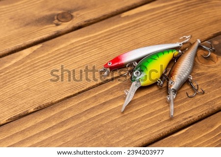 Image of lure fishing on wood grain background.