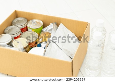 Emergency food stored in cardboard boxes. Royalty-Free Stock Photo #2394205559