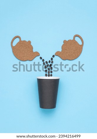 Coffee beans are poured from two teapots into a paper cup. The concept of a popular invigorating drink.
