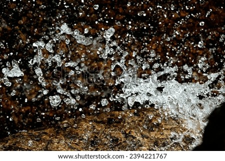 Closeup of rushing water in Andrews Brook, stopped in action with high shutter speed and flash, in Newbury, New Hampshire. 