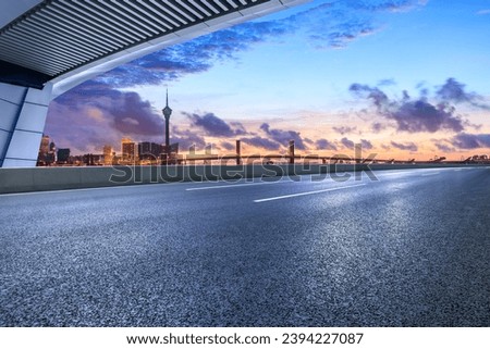 Asphalt highway road and city skyline at sunset in Macau, China.